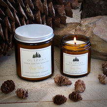 Load image into Gallery viewer, both 4 and 8 ounce Ylang Ylang candles in amber glass jars with metal lids.